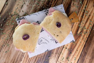 sandwich on a restaurant table with a wooden background.