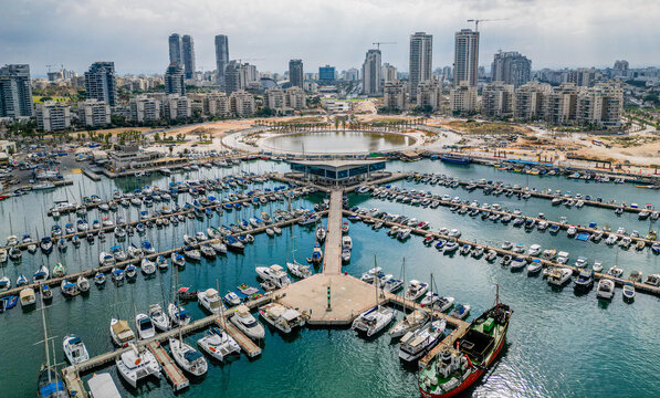Ashdod city complete beautiful panoramic aerial view from the sea showing it modern marina symmetric open landscape and sky scrapers in the distance with overcast skies