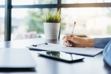 Freelancer or Business woman working in finance and accounting Analyze financial listing sale report, analysis and strategy concept.