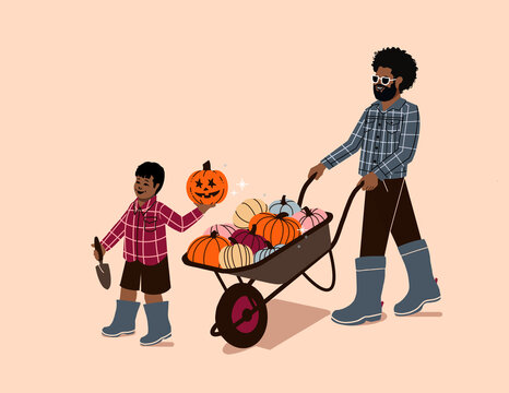 father and son pumpkin wheelbarrow - happy child and parent pumpkin picking patch - pumpkin farm harvest activity - black family autumn - dad and boy
