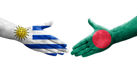 Handshake between Bangladesh and Uruguay flags painted on hands, isolated transparent image.