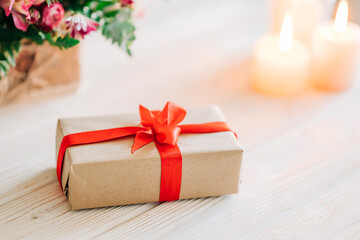 Saint Valentine day: red ribon, romantic gift box, candle on white background.