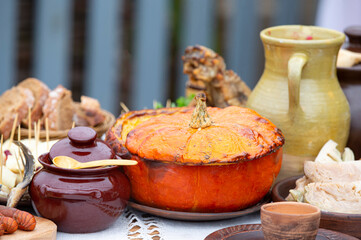 Beautiful autumn menu, stewed pumpkin and earthenware.