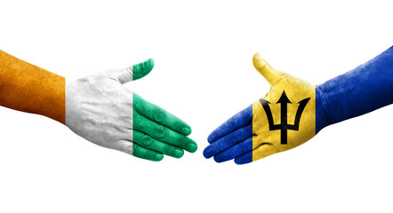 Handshake between Barbados and Ivory Coast flags painted on hands, isolated transparent image.