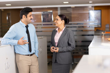 Young couple discussing about business in the modern office