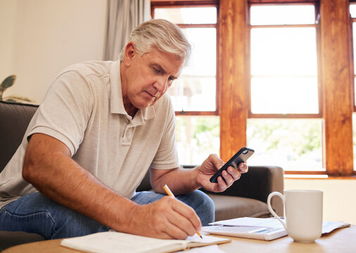 Smartphone, budget planning and senior man in living room for retirement research, website investment information or asset management. Elderly person writing notes, using phone online finance banking