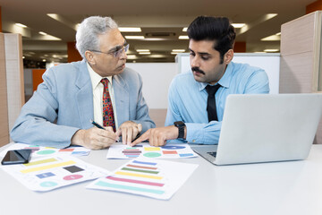 Man with old father using laptop while planning budget finance in office.