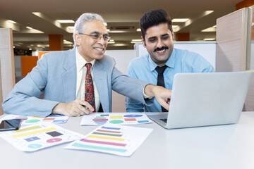 Man with old father using laptop while planning budget finance in office.