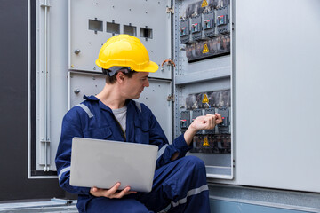 Electrical engineer working in control room. Electrical engineer man checking Power Distribution Cabinet in the control room