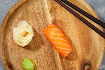 tasty sushi with salmon on a wooden background