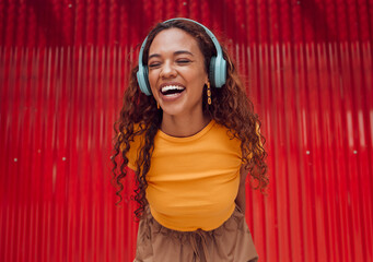 Urban, joy and woman with headphone music enjoying happy rhythm with bluetooth connection. Smile of...