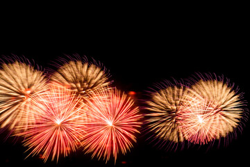 Close-up of colorful fireworks on a black background.