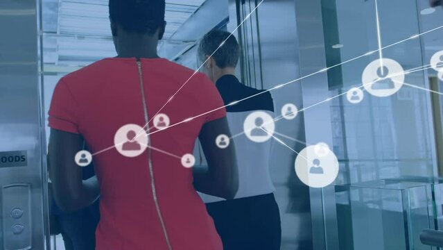 Animation of network of profile icons over diverse businesspeople entering the elevator at office
