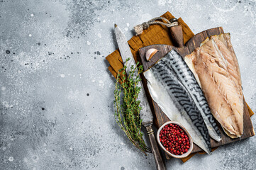 Cooking of fresh raw mackerel fillet fish on a cutting board. Gray background. Top view. Copy space