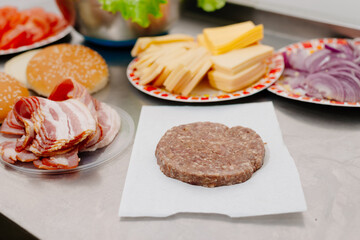 The process of making a burger. Ingredients for making a burger. Everything you need to make a burger is laid out on the table.
