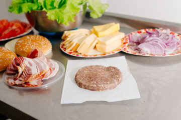 The process of making a burger. Ingredients for making a burger. Everything you need to make a burger is laid out on the table.
