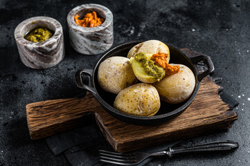 Papas arrugadas Canary islands wrinkled potatoes with green and red sauces served in a skillet....