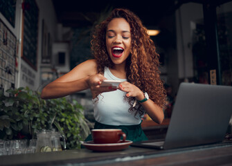 Coffee shop, influencer and woman taking picture of coffee on phone and working on laptop. Happy...