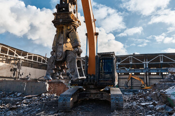 Excavator with hydraulic scissors demolition site