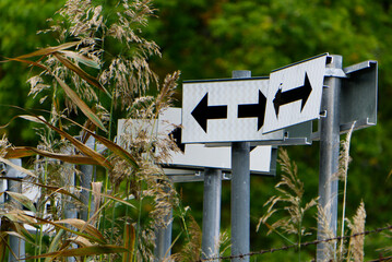 Several arrow signs with reed straws