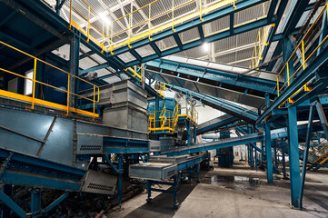 Large production line with conveyors carrying trash at plant