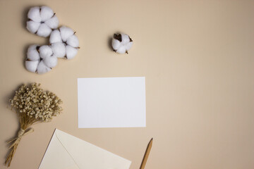 White letter with cotton flowers and envelope over the brown background. 