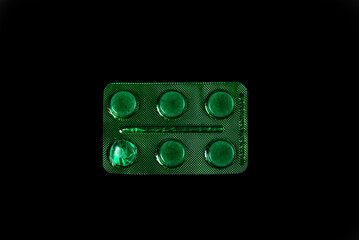 Сapsule pills in blister on a black background