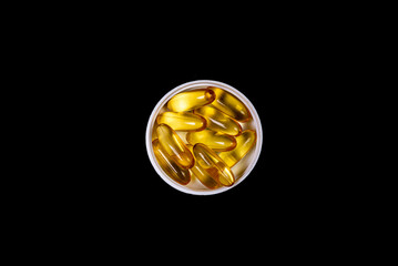 Medical orange pills on isolated on black background