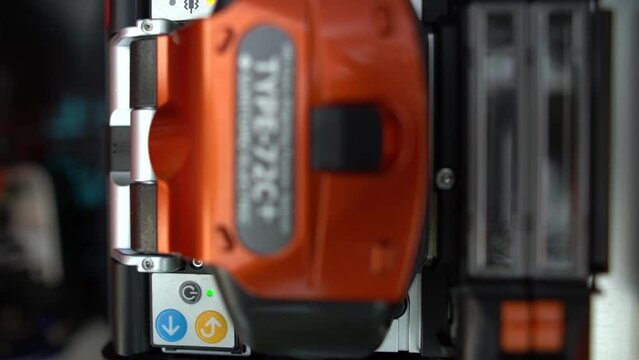 A close up shot of wire connection with Fiber Optic Fusion Splicing machine,fiber optic cable splice machine in work