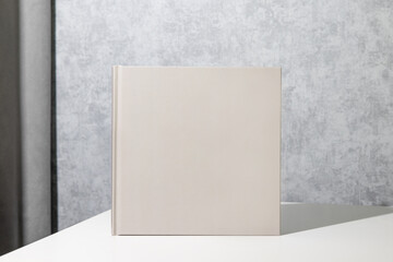 Grey book mock up, great design for any purposes. Technology concept. Business concept in grey room interior 