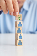 Businesswoman holding wooden block with light bulb on it. Idea concept.