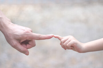 Asian father index finger collided with daughter girl hand on background ,father day