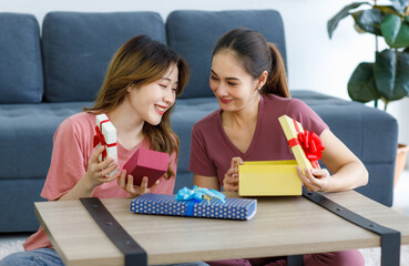 Asian young happy cheerful female teenager LGBTQ lesbian lover couple sitting smiling together on...