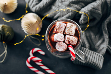 Glass with hot chocolate with marshmallow on dark blue background. Top view.