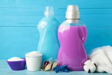 Laundry detergents with washing powder and capsules on blue background