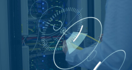 Composite of digital clock and circles over midsection of caucasian technician checking server