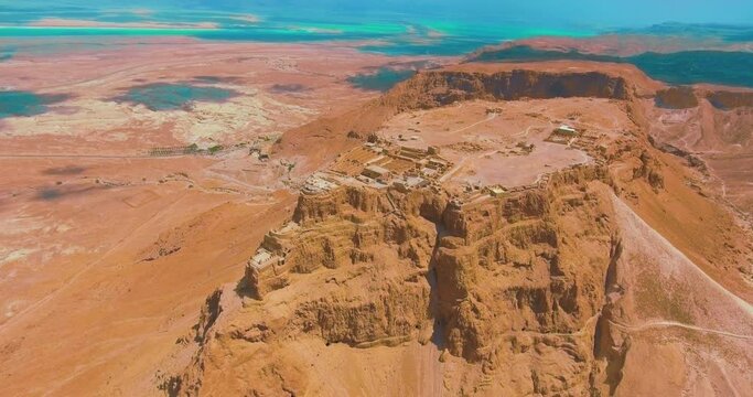 Masada is an ancient fortification in the Southern District of Israel situated on top of an isolated rock plateau, akin to a mesa. It is located on the eastern ed