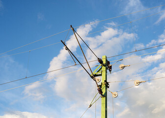  Suspended electric lines for trams against the blue sky.