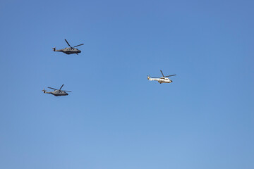 Helicopter. Airplane. Military vehicle. Spanish Air Force on the day of the National Holiday of October 12 flying over the streets of the city of Madrid. MADRID, SPAIN - OCTOBER 12, 2023