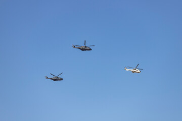 Helicopter. Airplane. Military vehicle. Spanish Air Force on the day of the National Holiday of October 12 flying over the streets of the city of Madrid. MADRID, SPAIN - OCTOBER 12, 2023