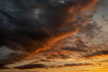 Sunset sky with orange clouds. Nature background.