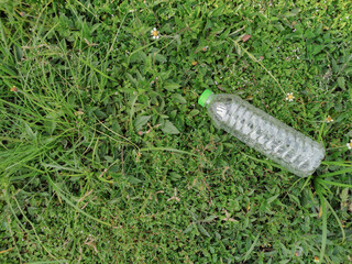 A bottle of water on the grass.