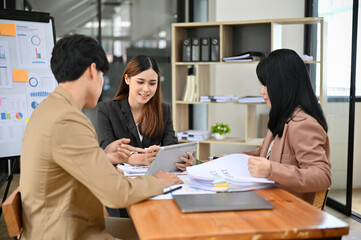 Group of a professional Asian businesspeople working together in the meeting room.