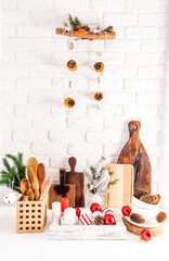 a brick white wall and a wooden table with eco items in the kitchen and handmade decorations for the New Year. ideas of the interior of an eco kitchen