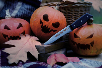 Halloween concept, still life of ripe pumpkins with painted evil faces. Composition of pumpkins,...
