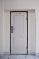 The door was tightly closed, part of the solid wall of the building.