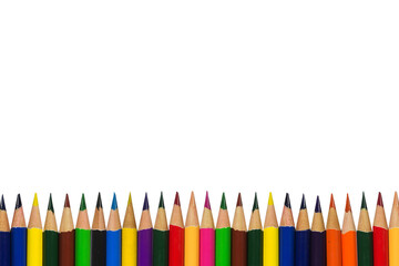Many multicolored pencils lined up in a row isolated on white background with copy space, Art and education background