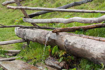 Water streaming into wooden bathtub. Relax photo image.