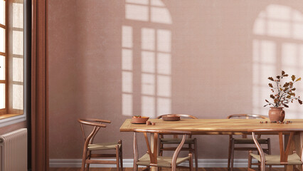 Farmhouse dining room with wooden table and chairs in orange and beige tones. Plaster walls, boho interior design