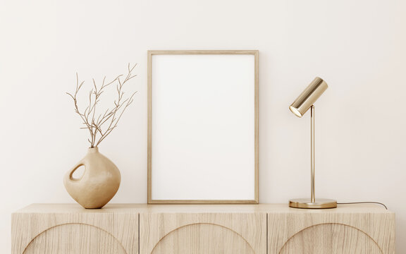 Vertical small wooden frame mockup standing on sideboard in warm neutral beige interior decorated with brass lamp and dried branch in vase. 3d illustration, 3d rendering